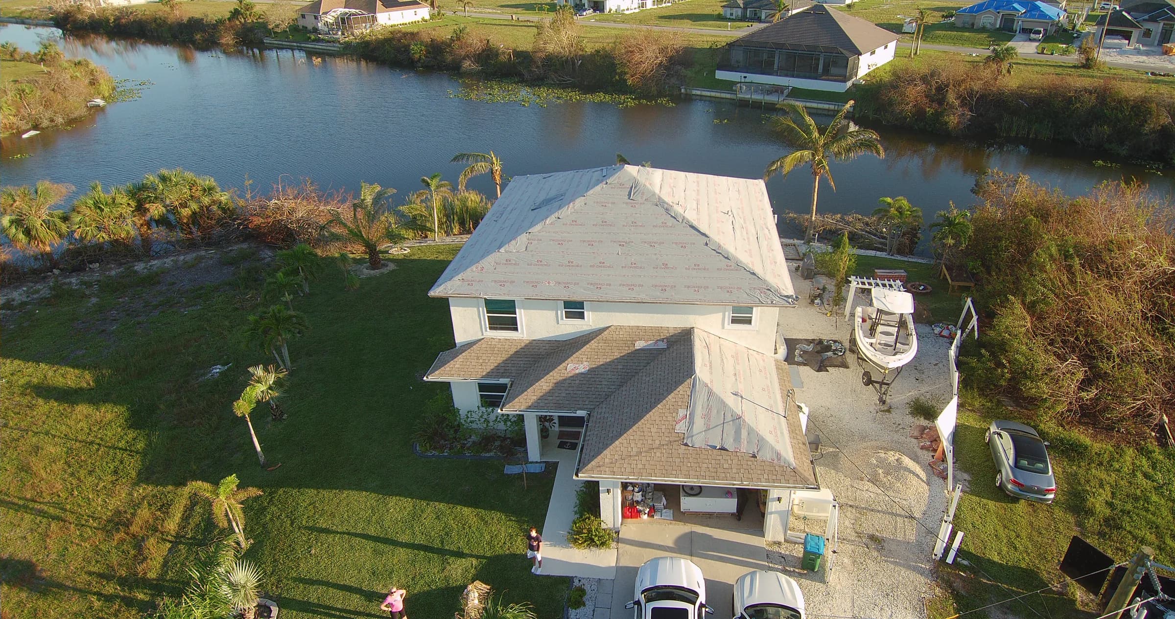 Oblique aerial view documenting exposed roof underlayment during tile roof work