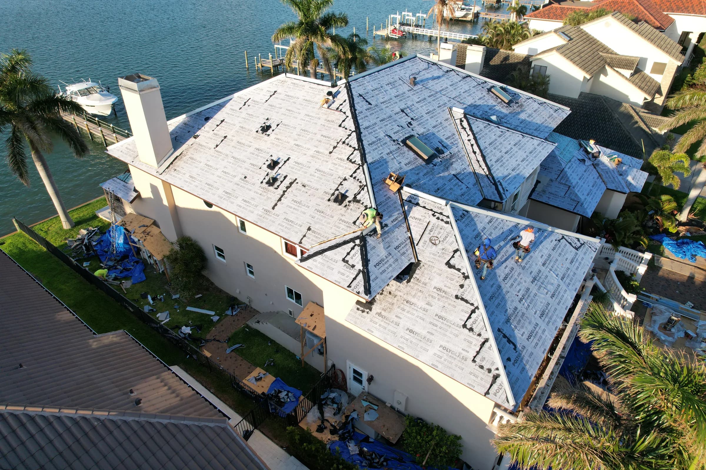 Aerial view of the roof fully covered in gray printed underlayment with seams and penetrations sealed