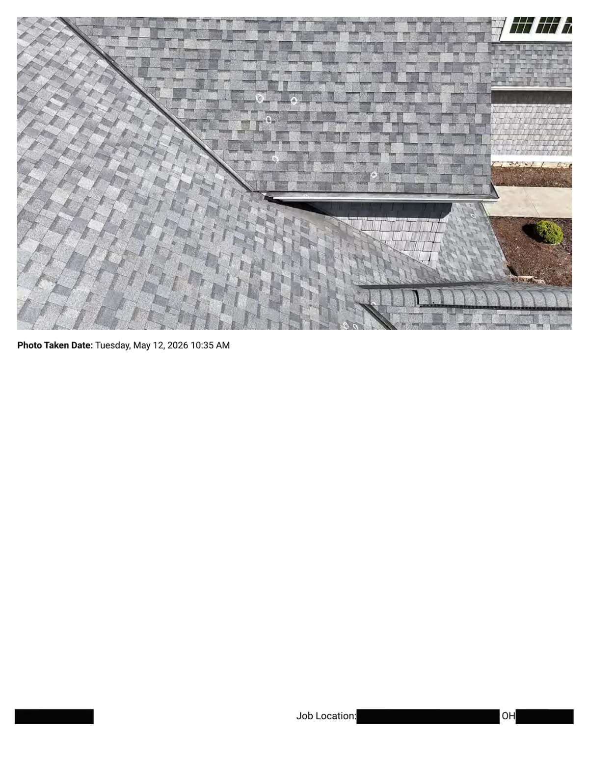 A roof slope with chalk-circled hail impacts near the eave; the walkway and landscaping are visible below.