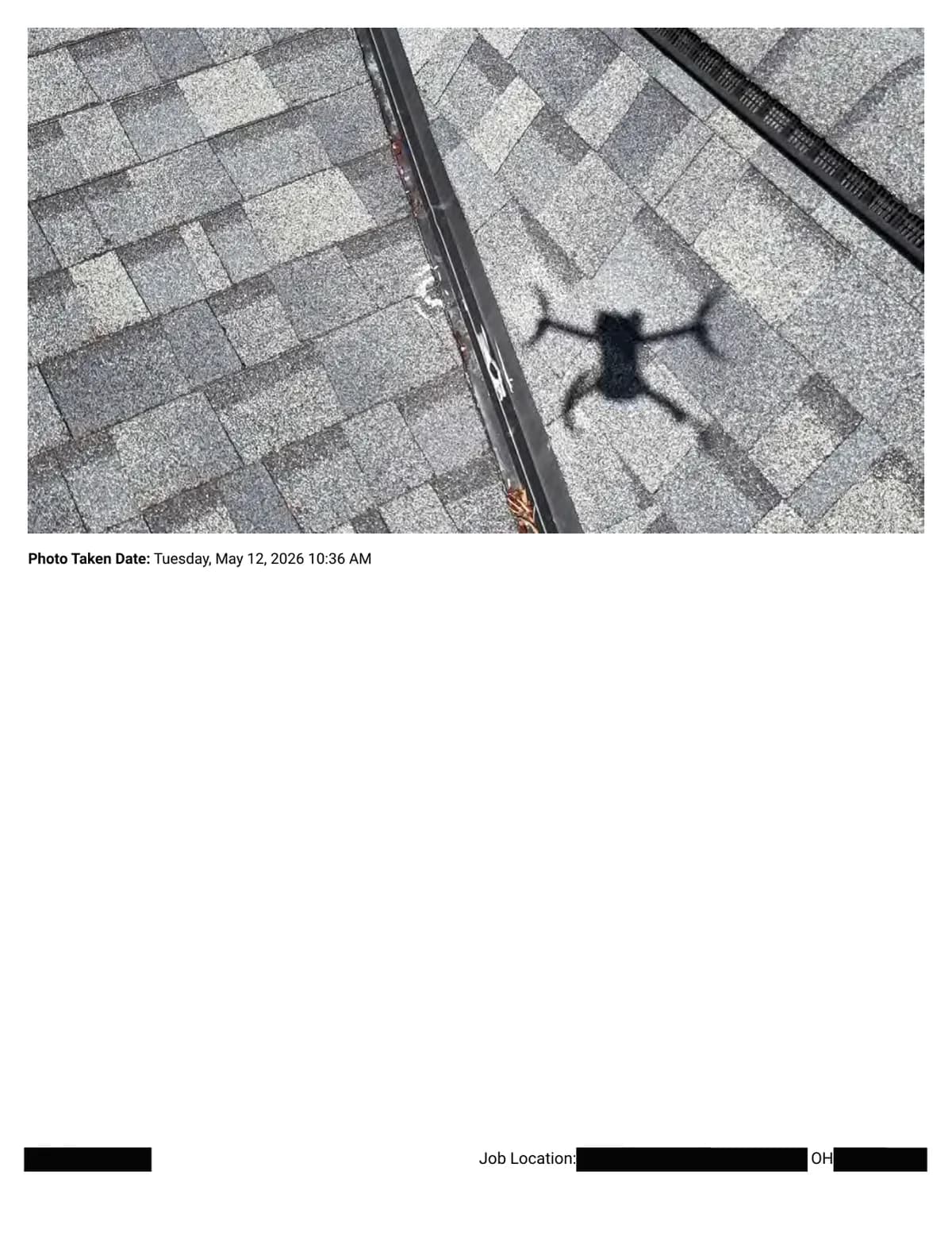 Roof slopes around a valley with chalk-marked impacts; the inspection drone's shadow is visible on the shingles.