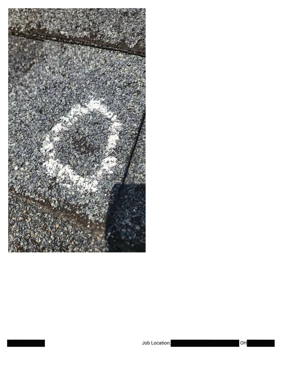 Extreme close-up of a chalk circle with a dark impact center where the granule layer is gone.