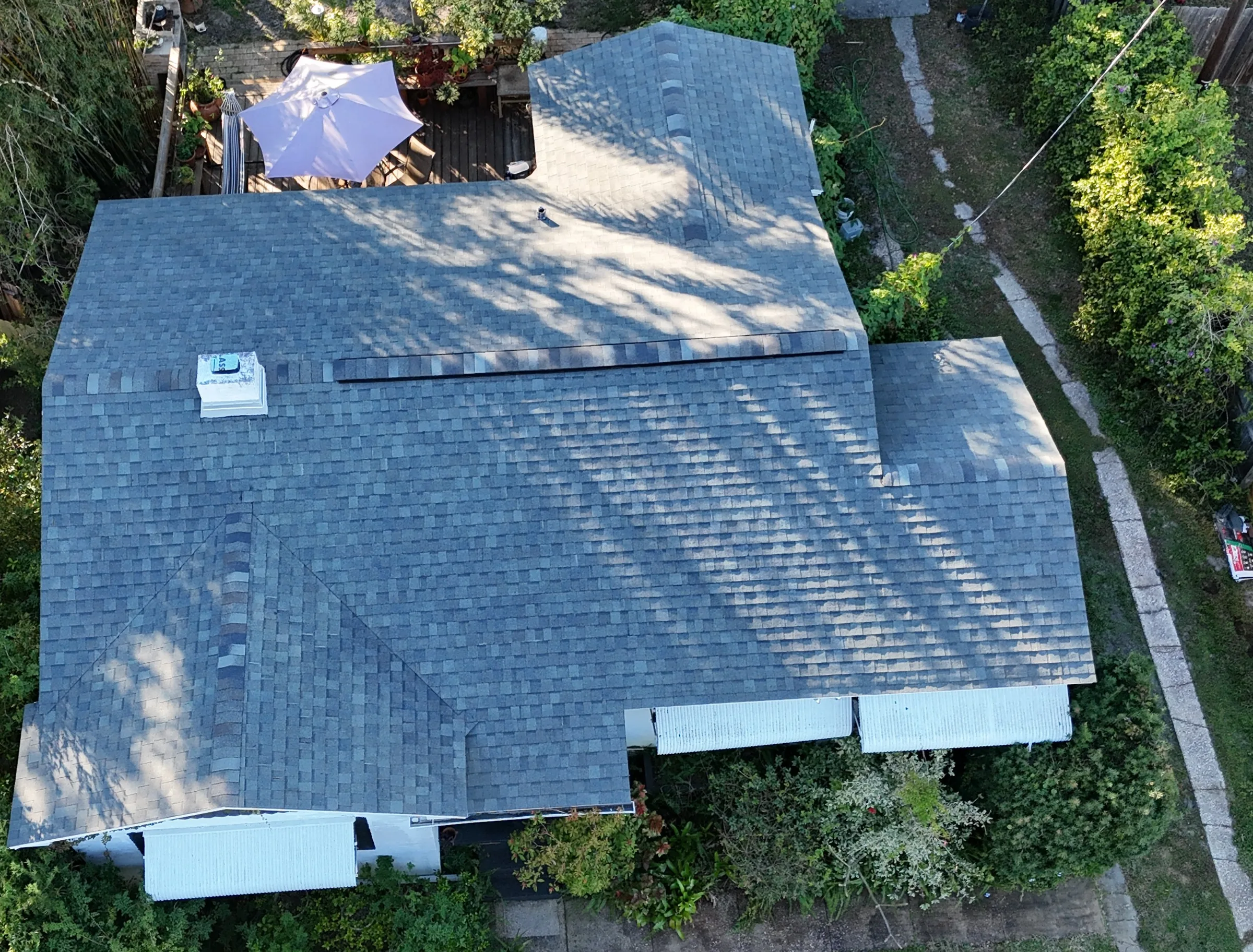 Overhead view of the completed gray architectural-shingle roof in St. Petersburg